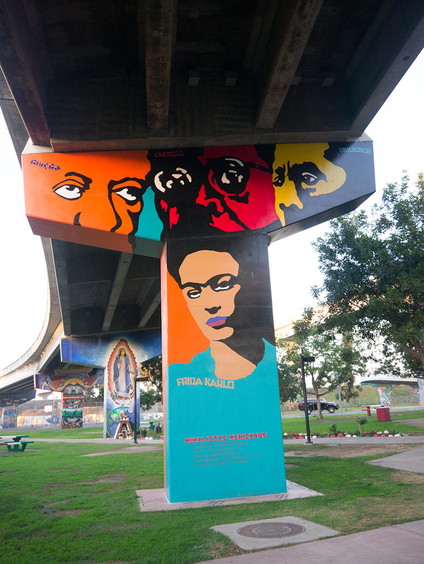A large mural painted on the side of a bridge.