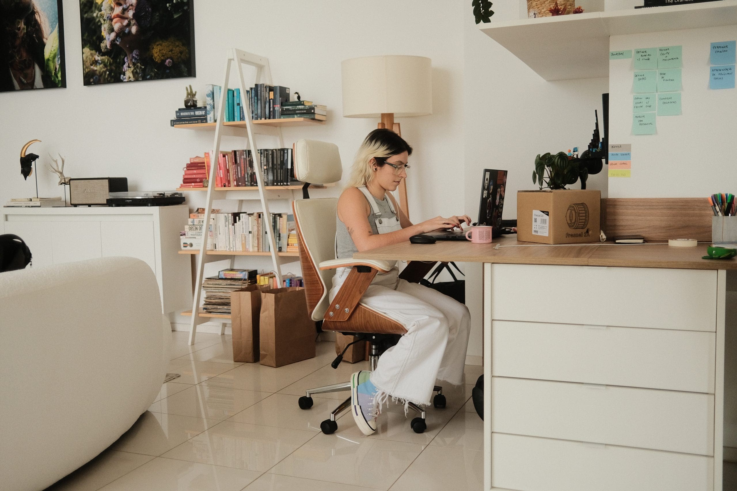 A woman working at a desk in her home office.