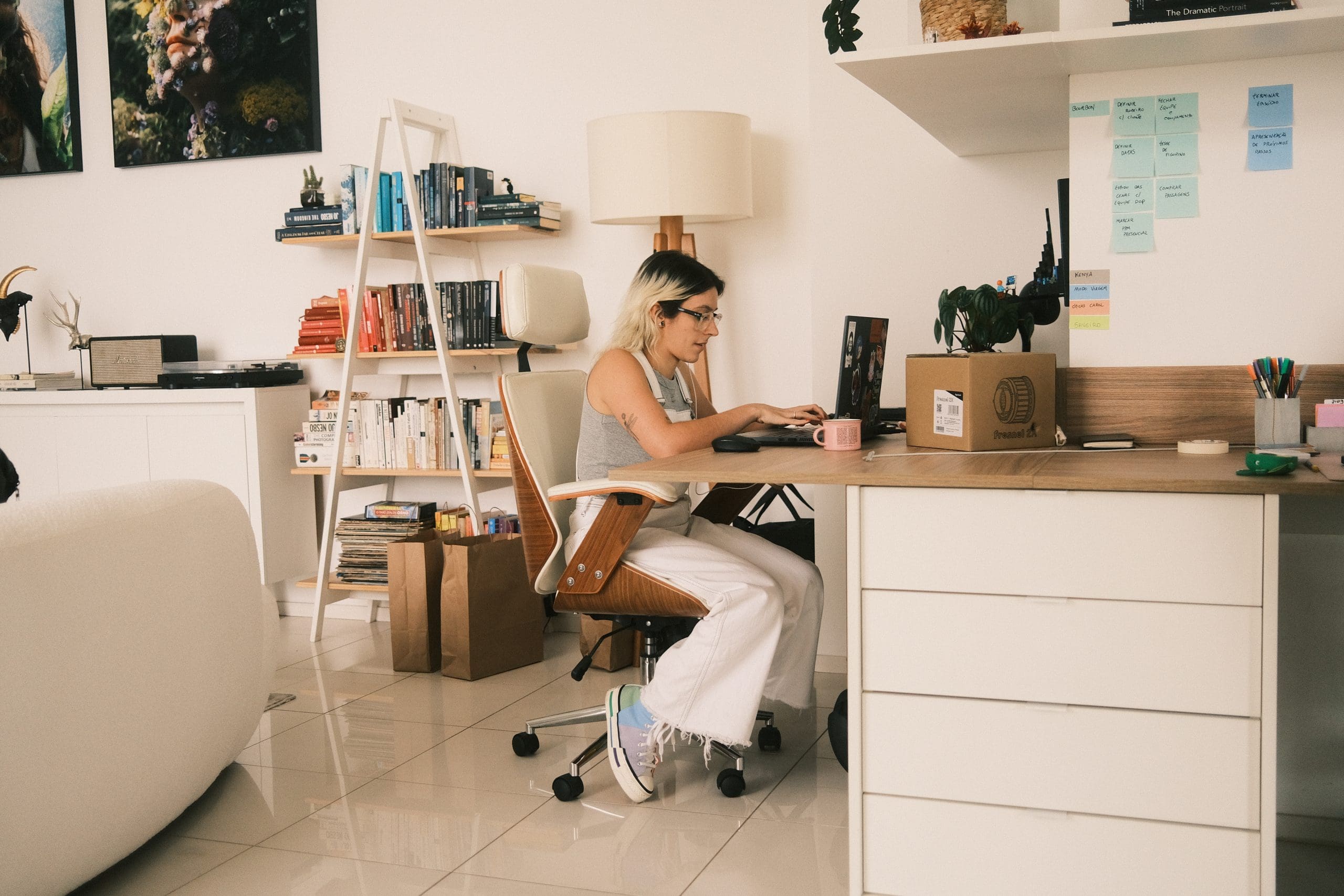 A woman working at a desk in her home office.