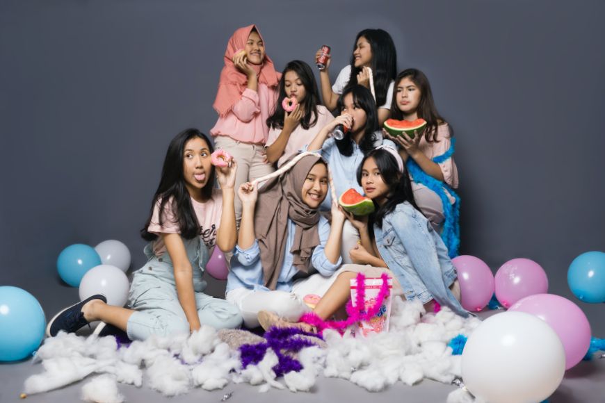 A group of girls posing with balloons and balloons.