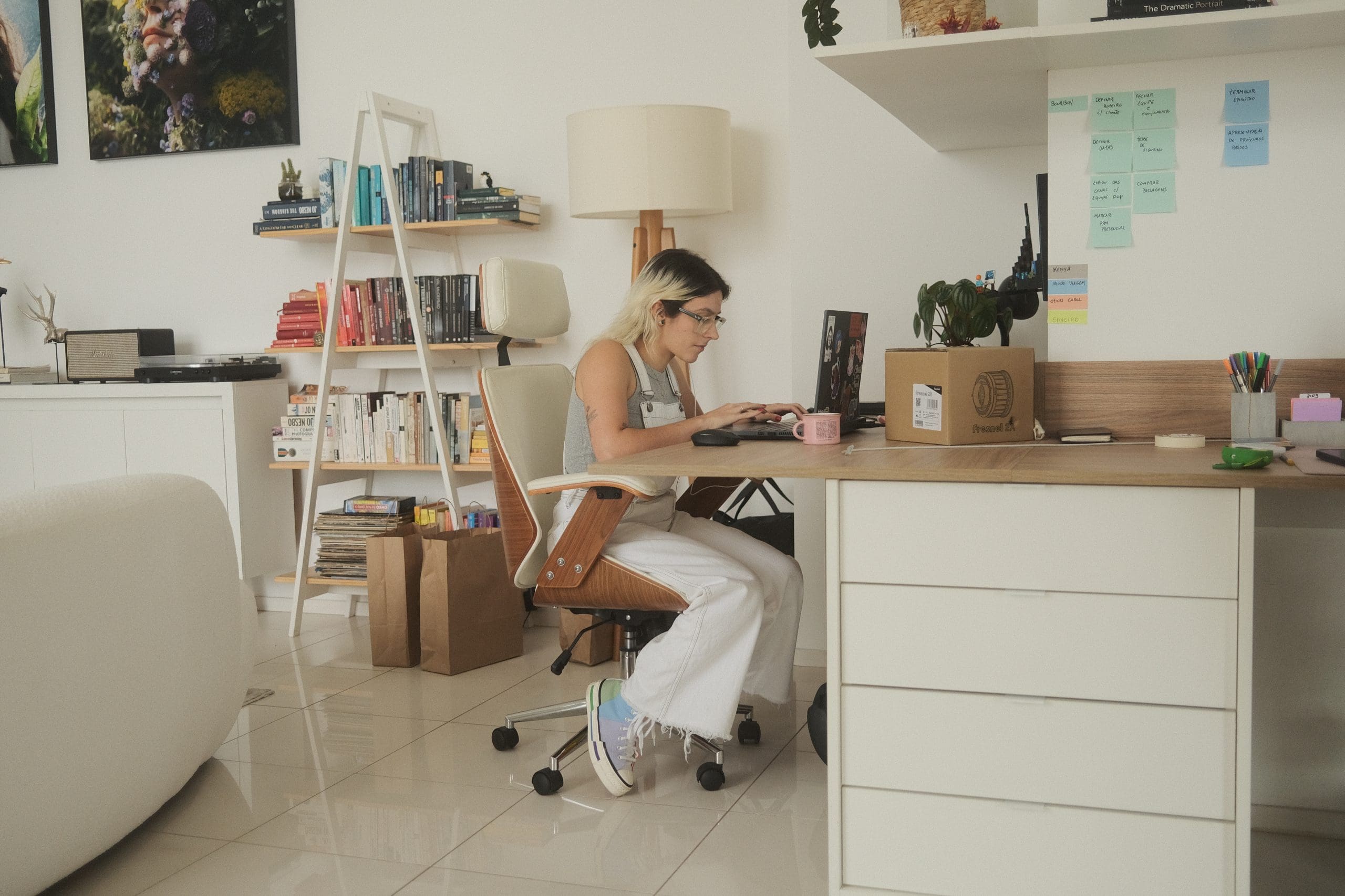 A woman working on a computer in a home office.