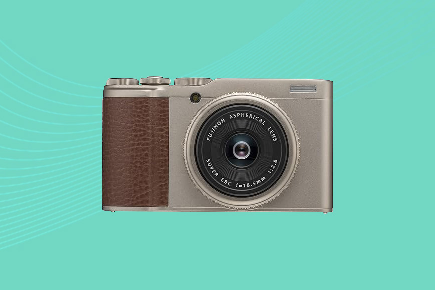 A camera with a brown leather cover on a turquoise background.