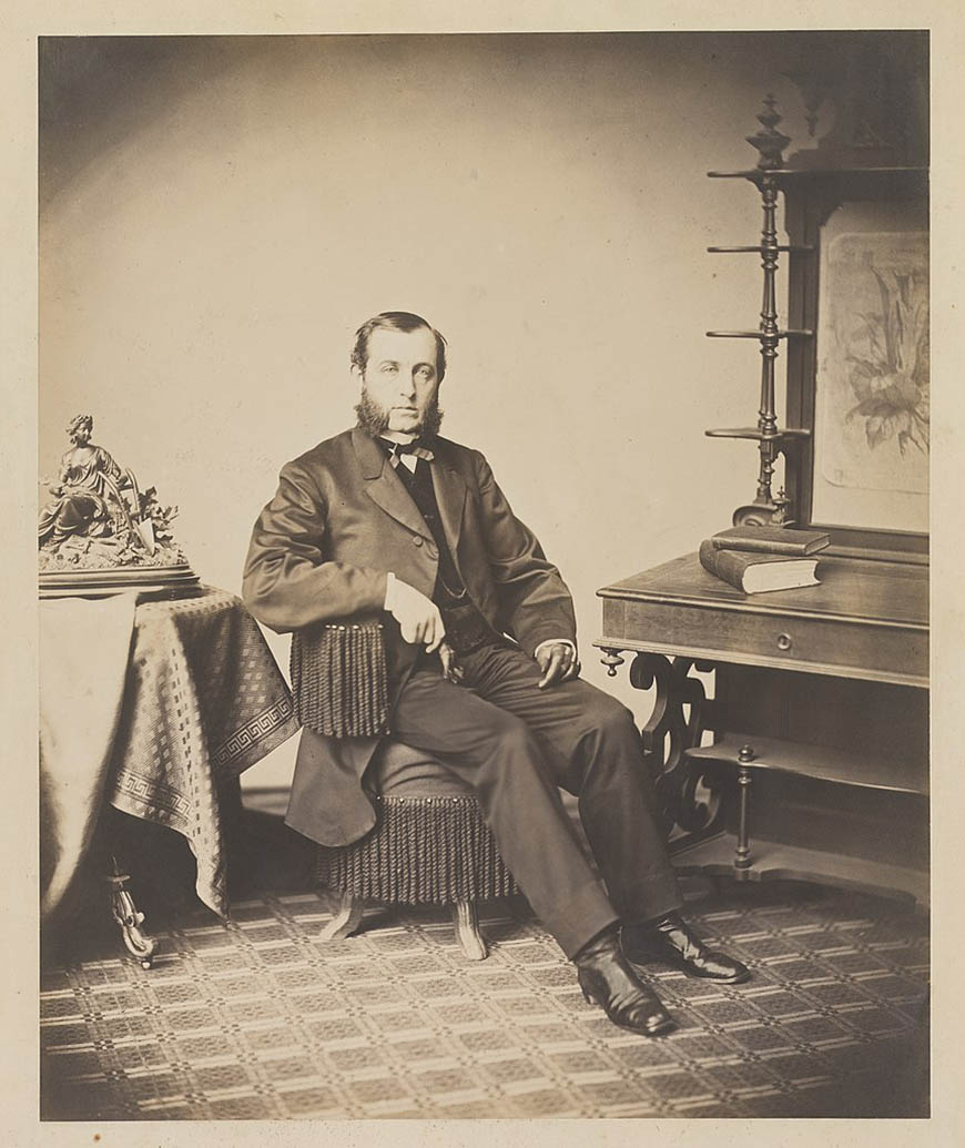 An old photograph of a man sitting in a chair.