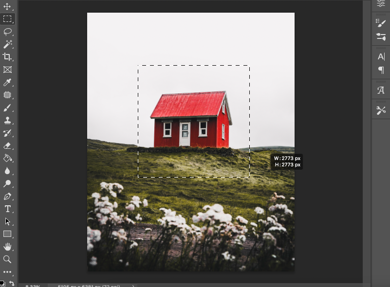 A photo of a red house in a field in adobe photoshop.