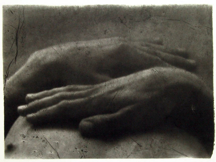 A black and white photograph of two hands.