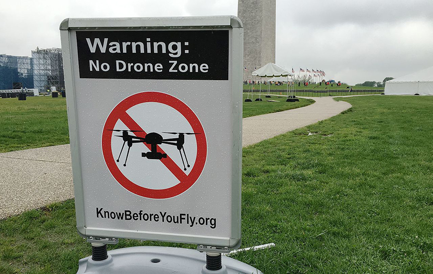 A sign warning no drone zone.
