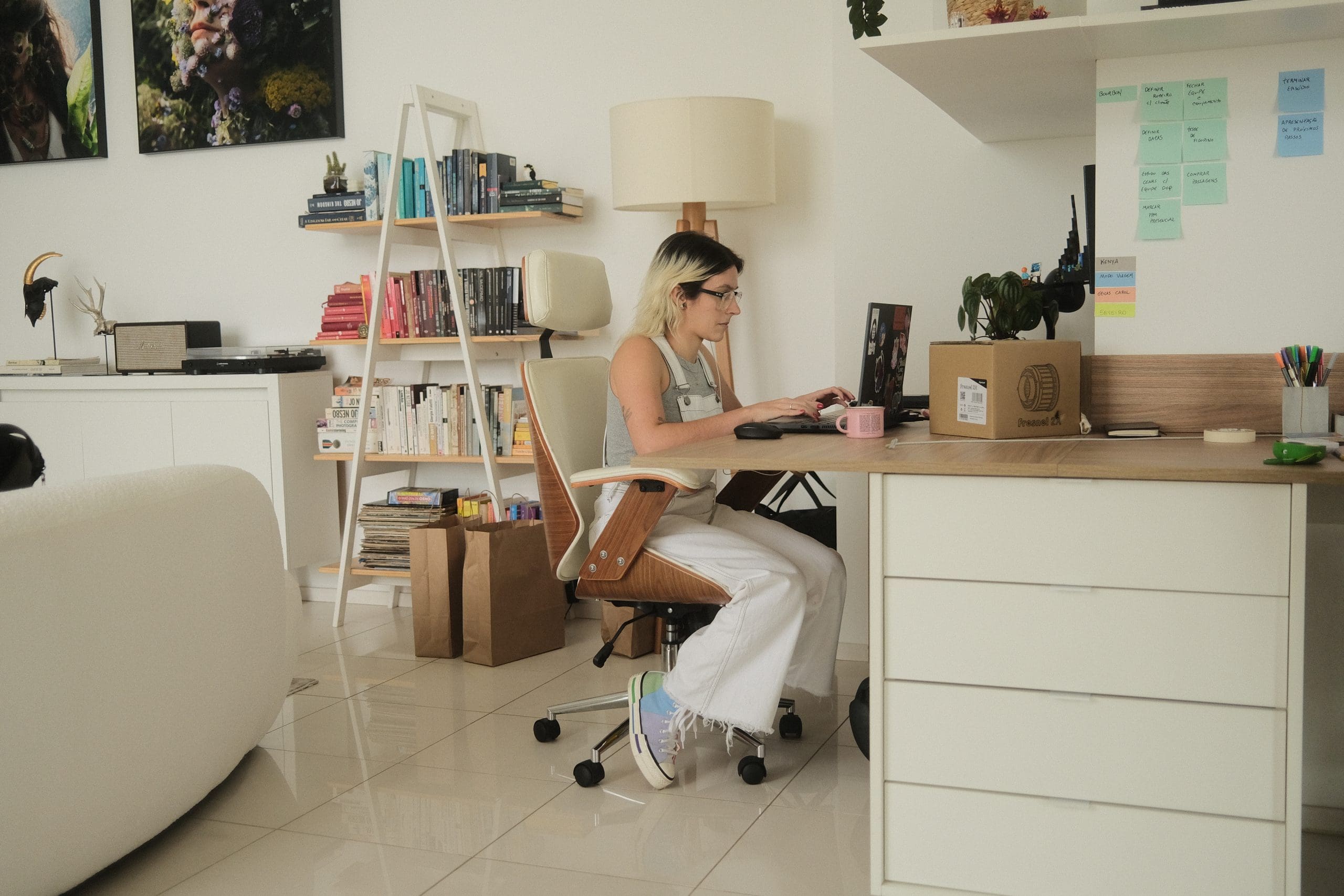 A woman working on a computer in a home office.