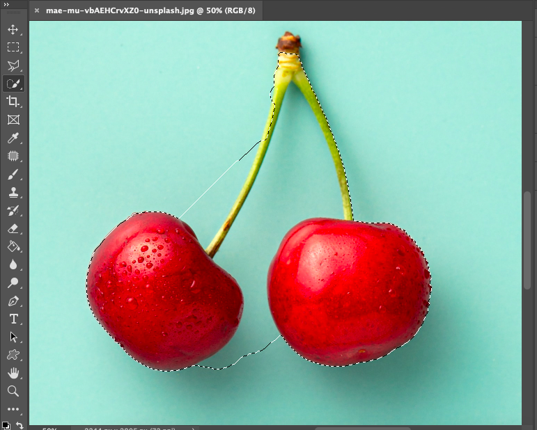 A photo of two cherries in adobe photoshop.