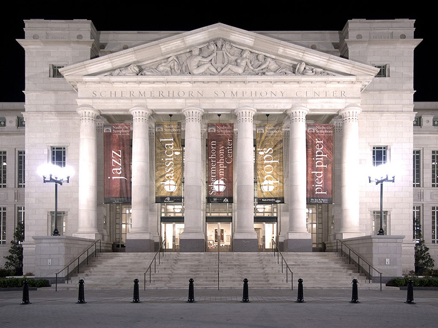 A building with columns and steps at night.
