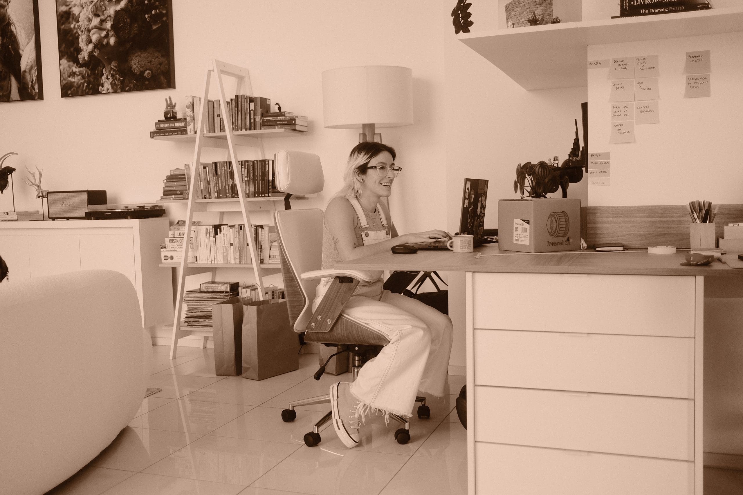 A woman sitting at a desk in a room.