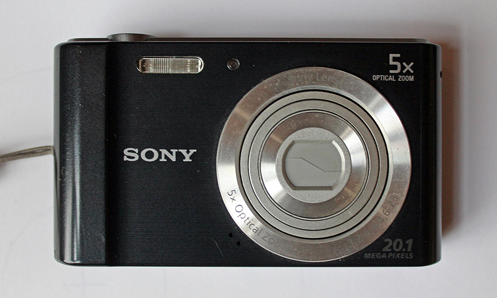 A sony digital camera on a white surface.