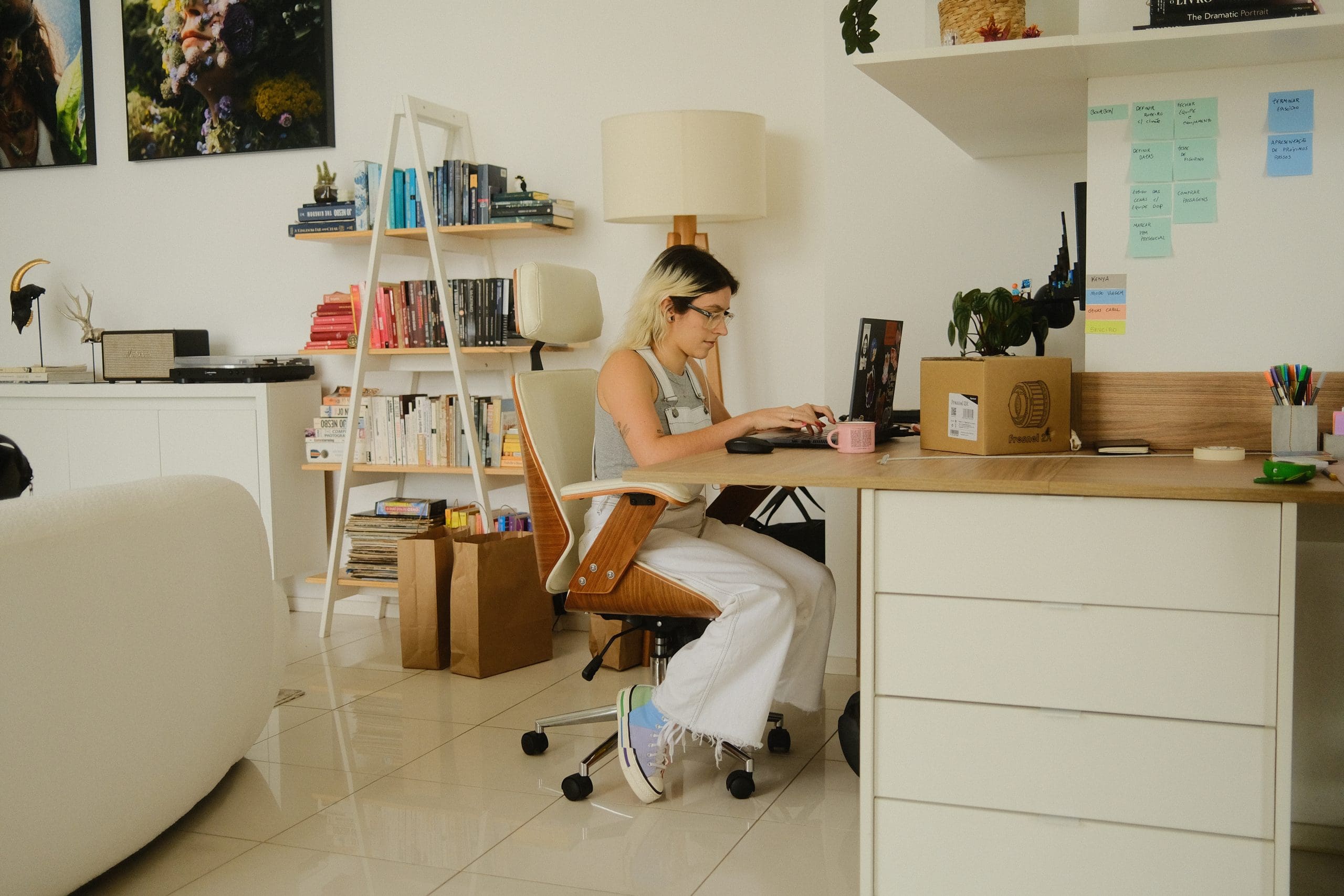 A woman working at a desk in a home office.