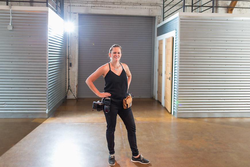 A woman standing in a warehouse.