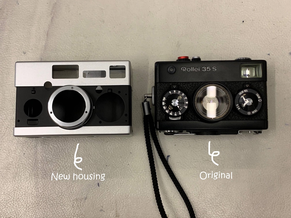 A black and white camera next to a black and white camera.