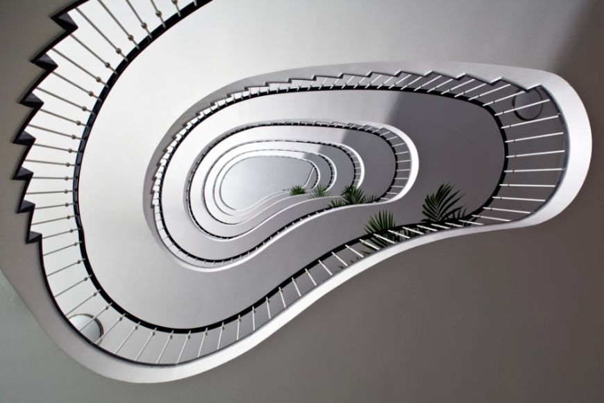 A spiral staircase in a white building.