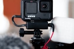 A gopro hero camera with a microphone attached to it.