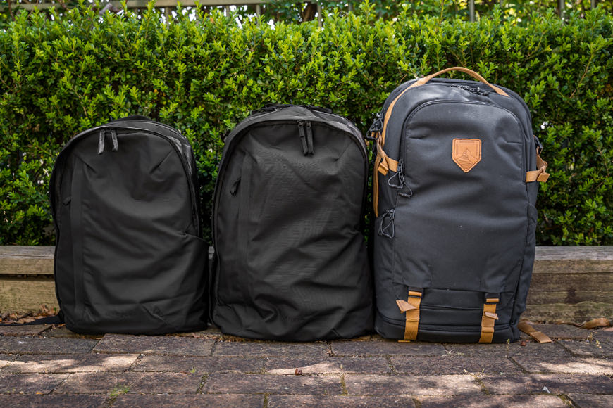 Three backpacks sitting next to each other.