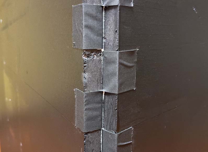 A hinge made of tape on foam board.