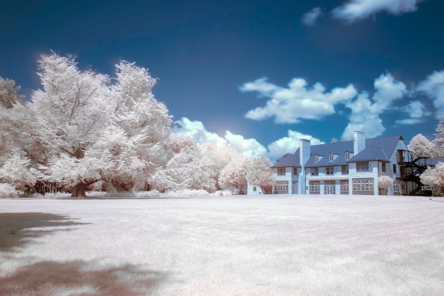 An infrared image of a house in a field.