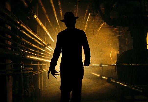 A silhouette of a man walking through a dark tunnel.