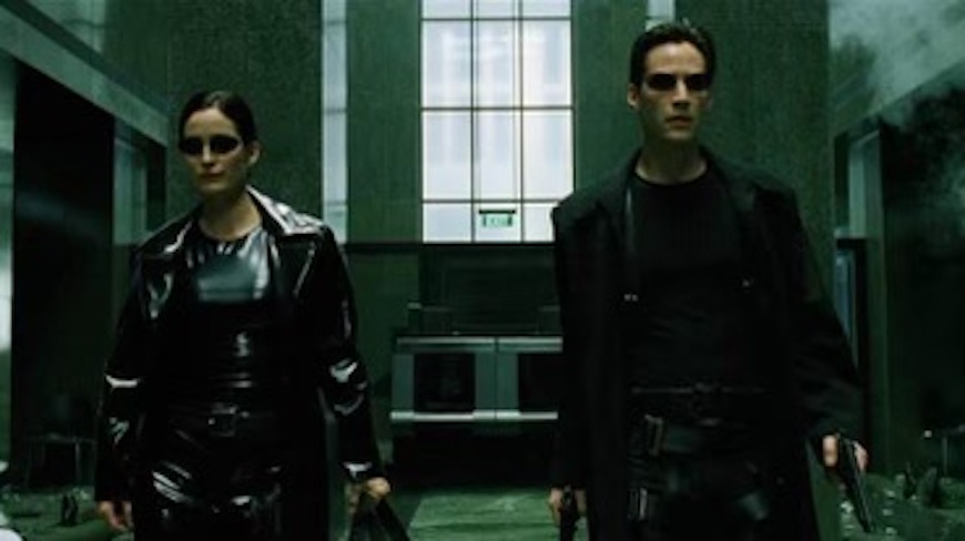Two people in the matrix standing in a hallway.