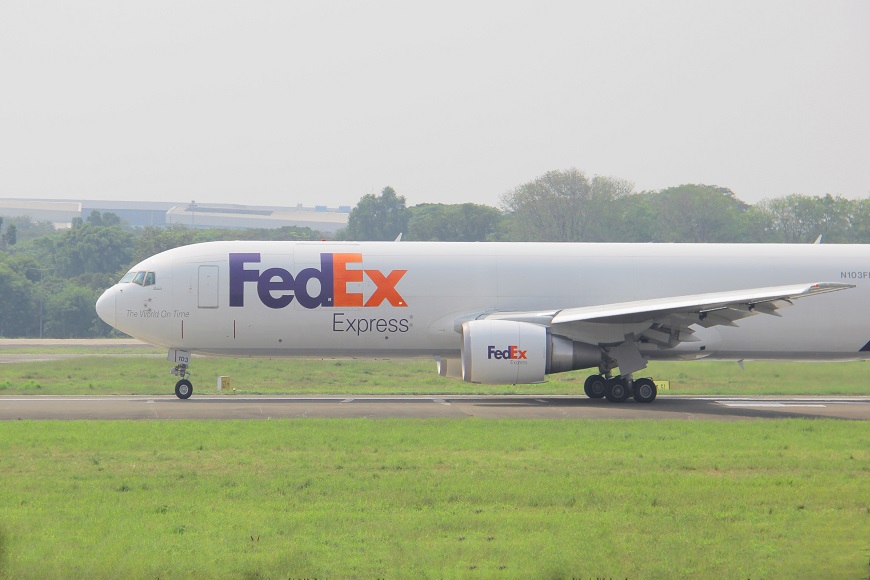 A fedex plane on a runway.