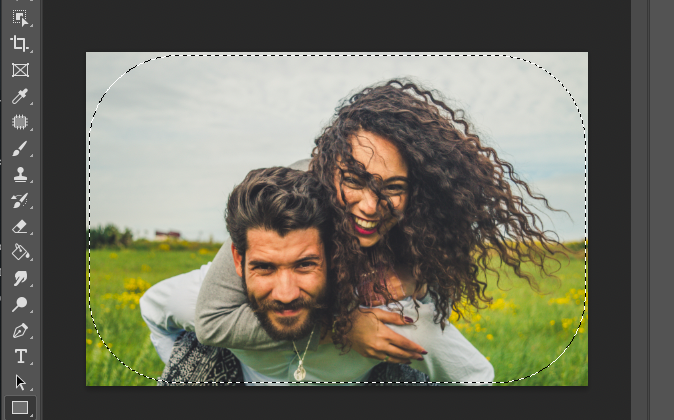 A man and woman hugging in a field in adobe photoshop.