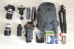 A backpack filled with camera equipment and other items.