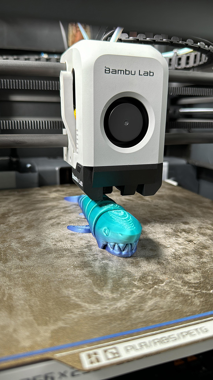 A 3d printer is being used to make a model of a fish.
