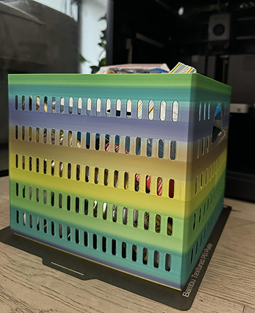 A colorful plastic storage box sitting on top of a desk.