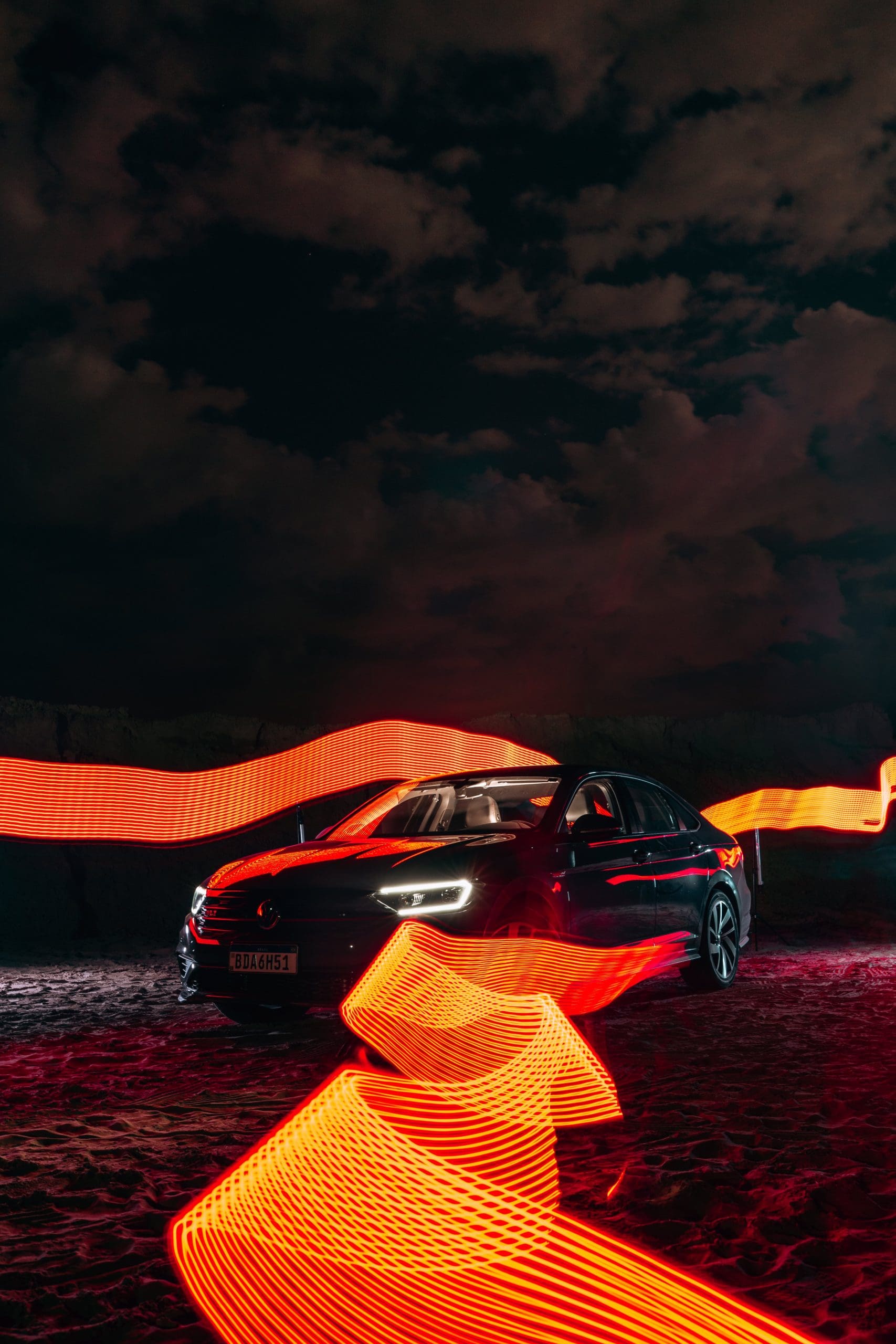 A car is lit up with red and orange lights.