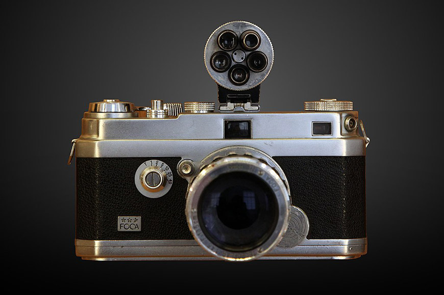 A silver camera on a black background.
