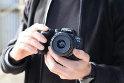 A man is holding a camera in his hand.