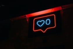 A neon sign with a heart and a heart in a rectangular frame.