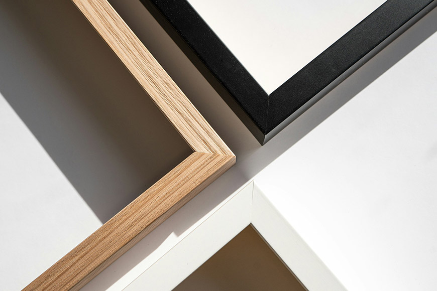 Three black and white frames on a white surface.
