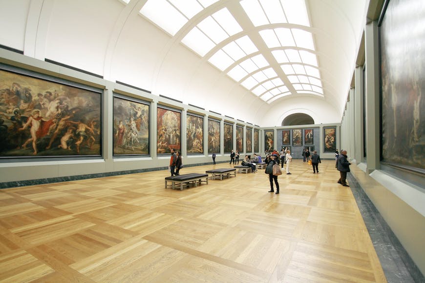 A large room with paintings on the walls.