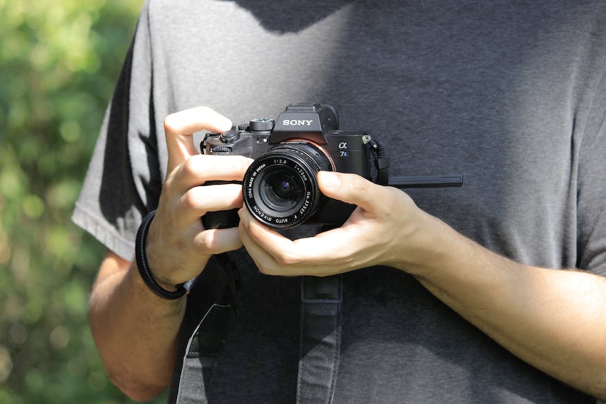A man holding a camera in his hand.