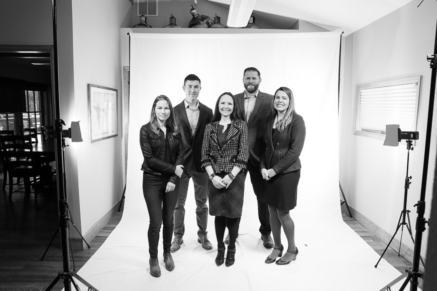 A group of people posing for a photo in a studio.