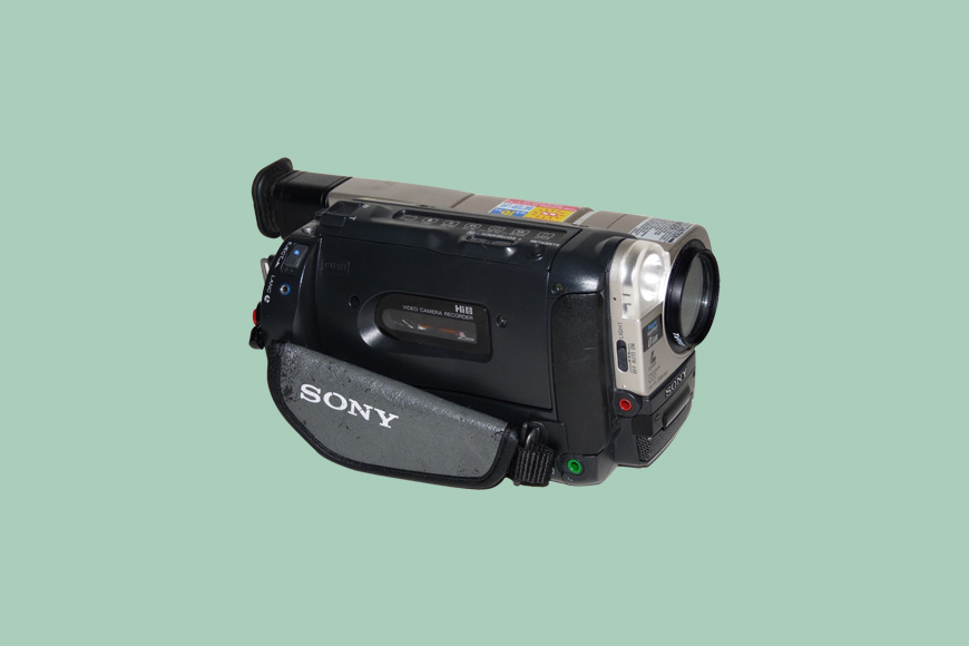 A sony camcorder on a green background.