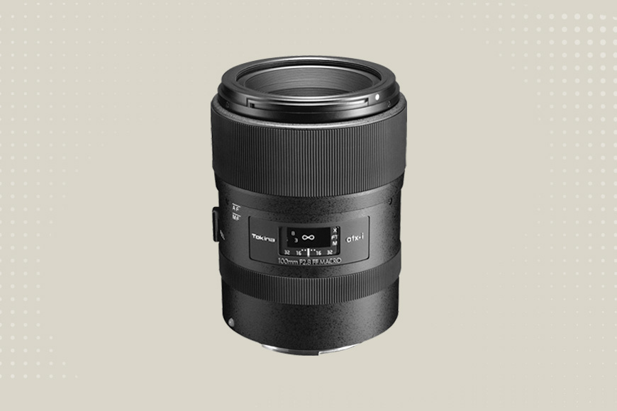 A black camera lens with a white background.