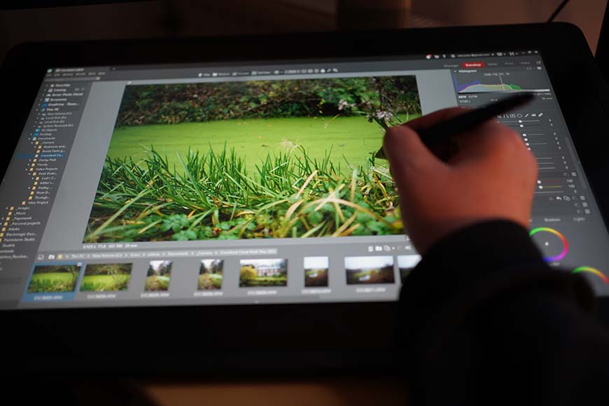 A person is using a tablet to create a photo.