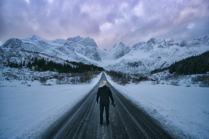 A person walking on a snowy road.
