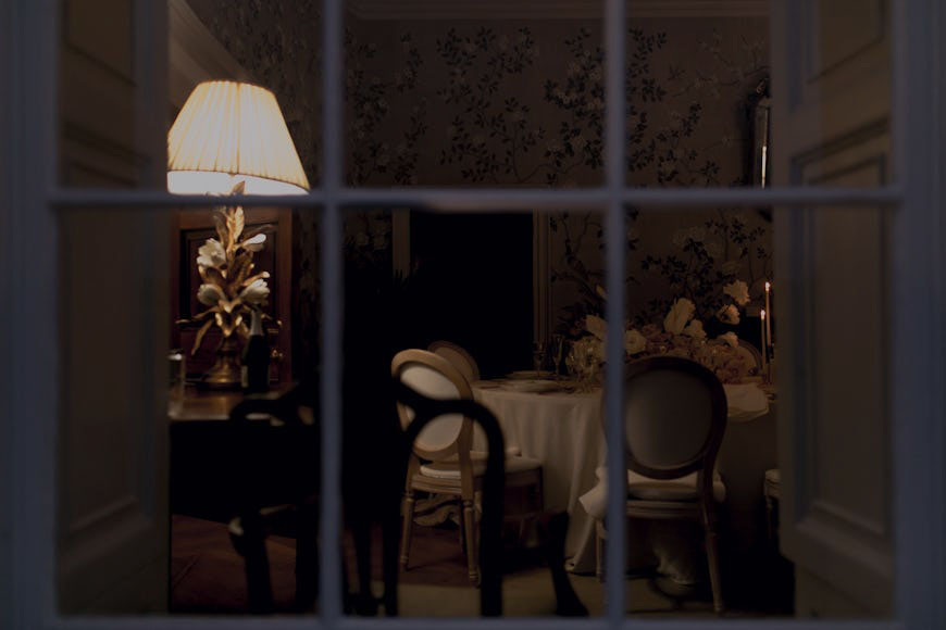 A window looking out at a dining room.