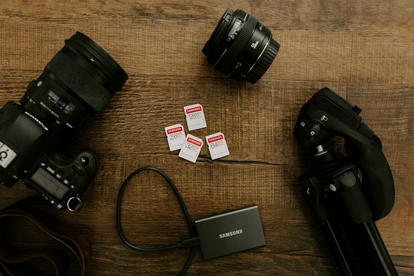 A camera and flash drives on a table.