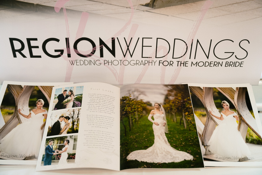 A brochure for a wedding photographer on display at a bridal expo.