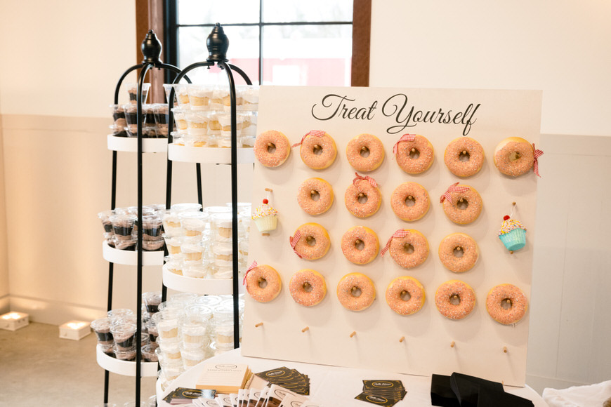 A display of donuts and cupcakes on a table.