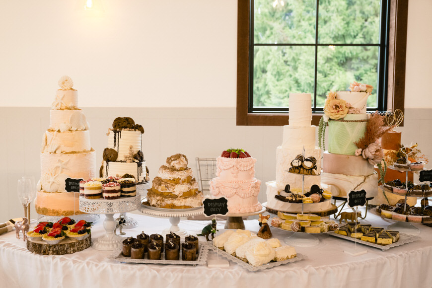 A table with a variety of cakes and desserts on it.