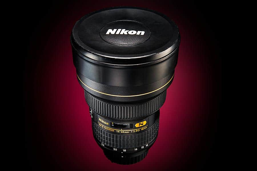 A nikon lens with a red background.