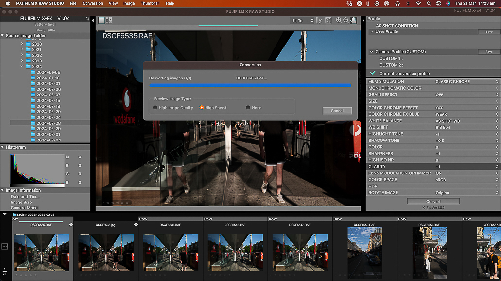 A screenshot of photo editing software in use, showing a compression process underway with a street scene photo displayed.