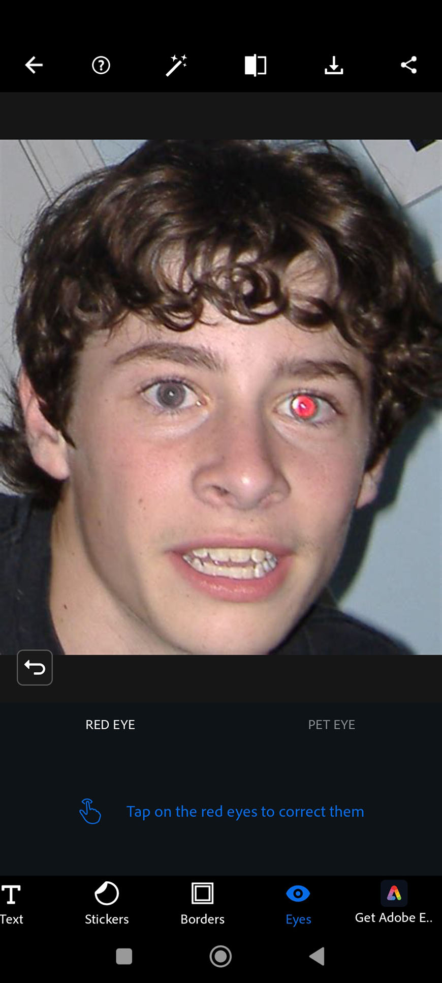 Young person experiencing red-eye effect in a photograph.